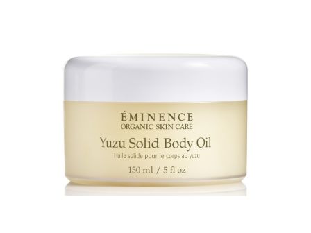 A jar of &Eacute;minence Organic Skin Care Yuzu Solid Body Oil, 150 ml / 5 fl oz, with white lid and yellow tinted container.